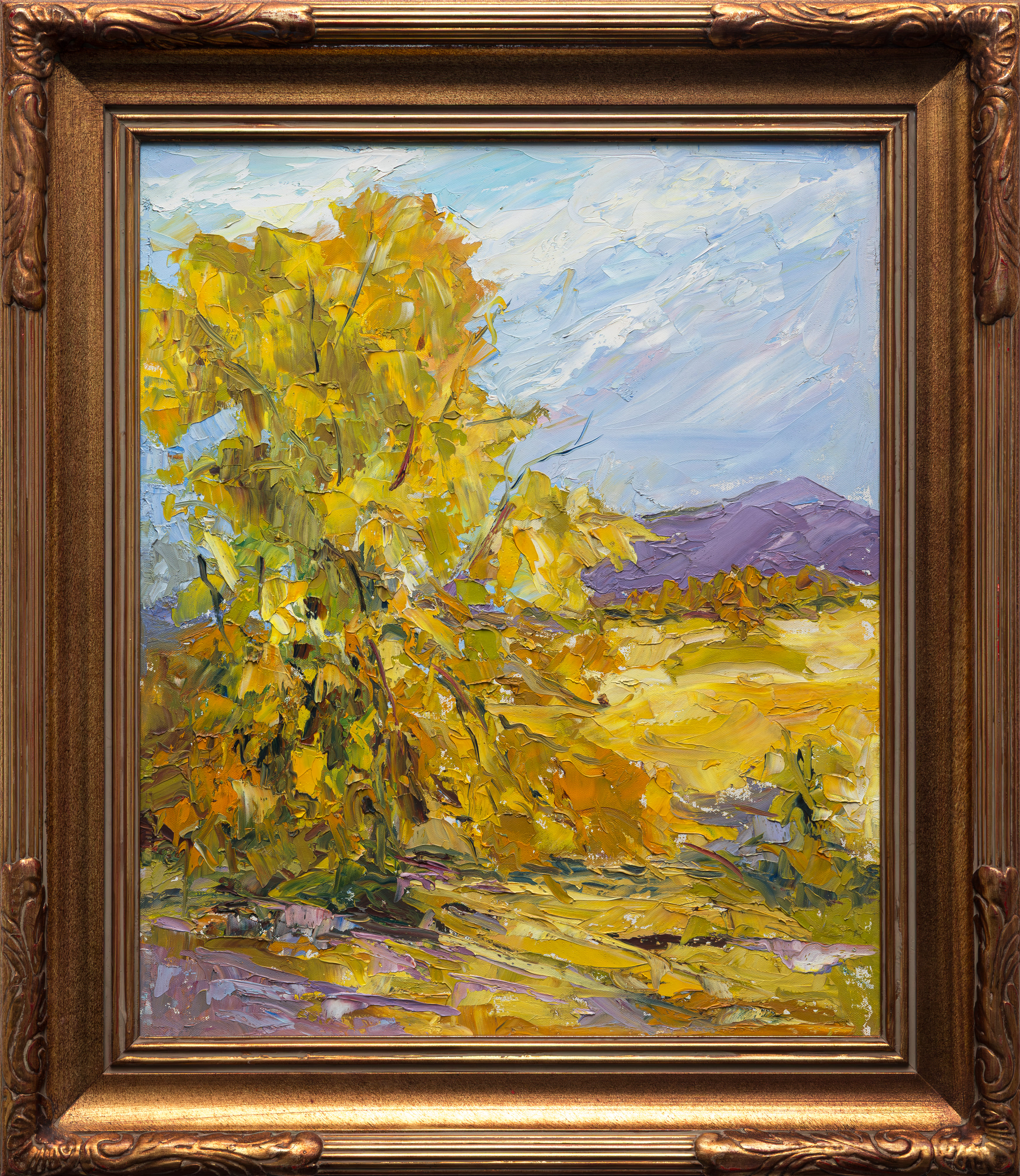 Golden Aspen on a Summer Day, a 1998 palette knife oil painting by Liz Richardson of a glowing golden aspen tree in a sunlit field with purple mountains behind.