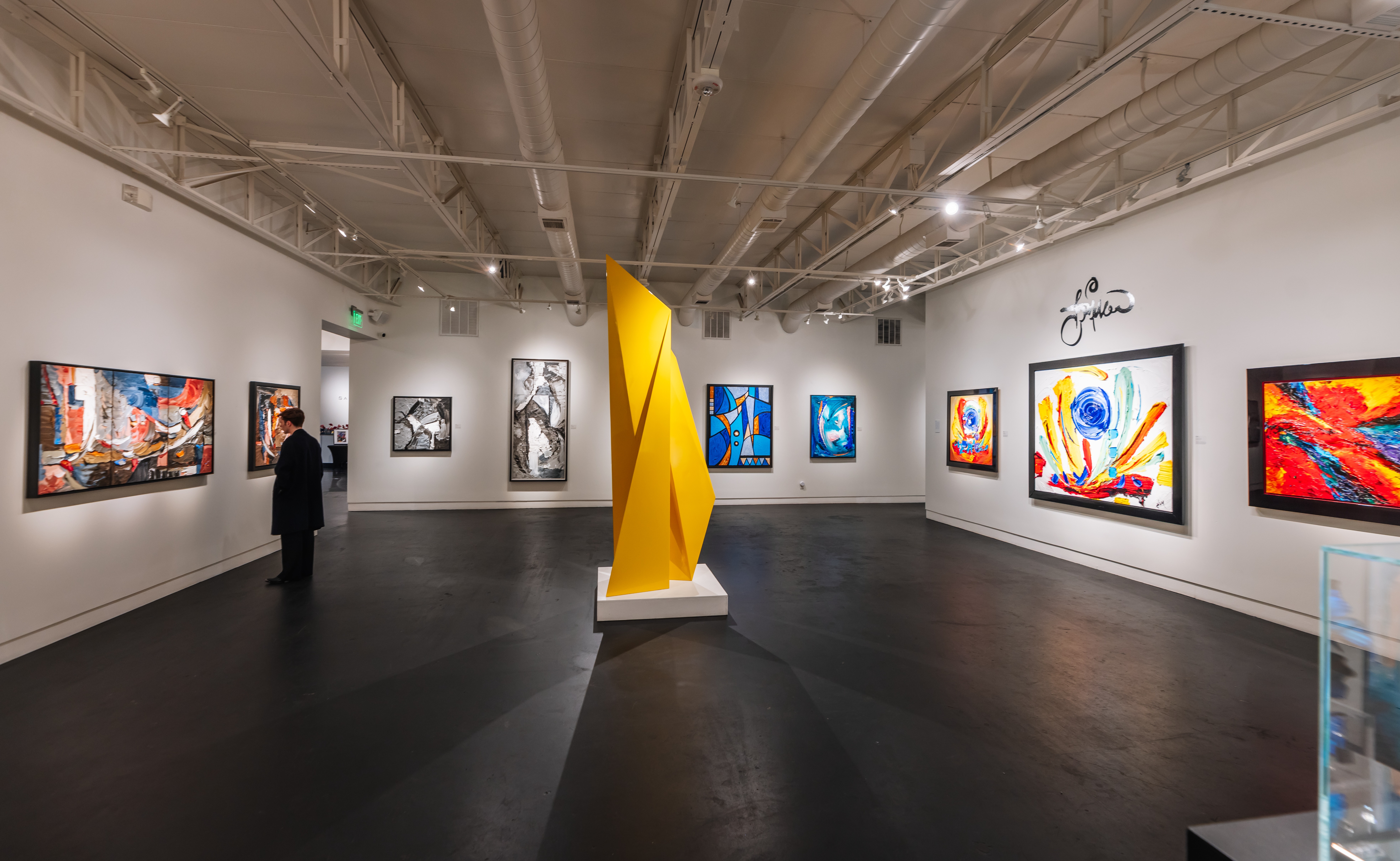 Samuel Lynne Galleries, Dragon Street, Dallas -- interior view with colorful paintings and a yellow sculptural form